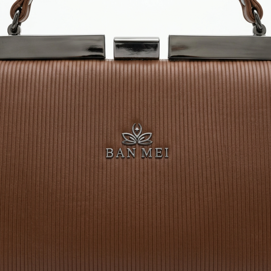 Ban Mei Frame Handbag in Brown — frame clasp detail